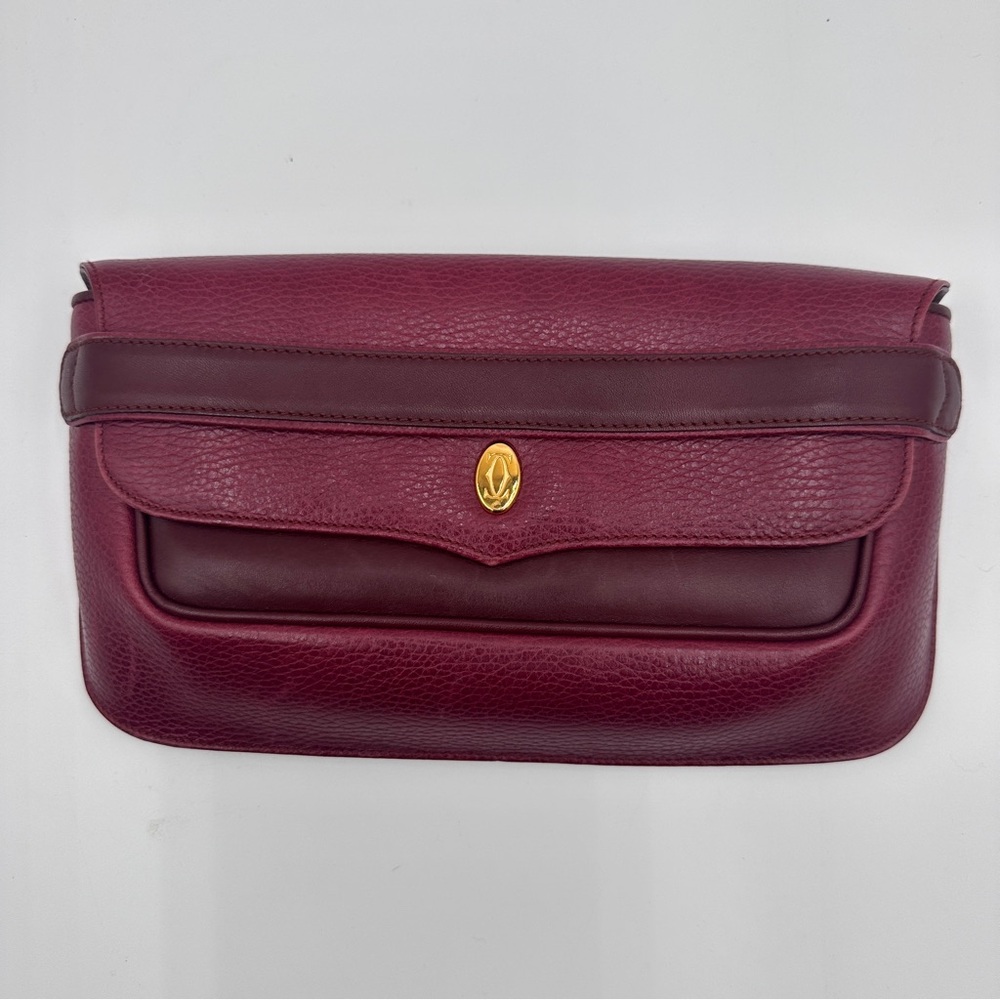 a vintage Must de Cartier clutch bag in Bordeaux leather with COA
